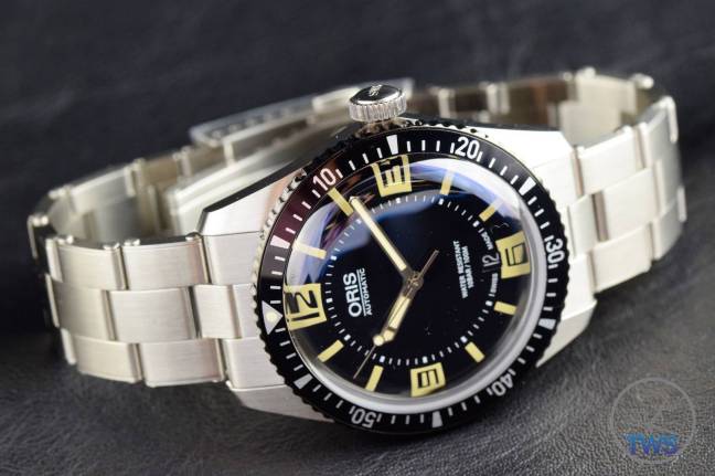 The Oris Divers Sixty-Five (With Metal Bracelet) [01 733 7707 4064-07 8 20 18] Laying on side on black background.